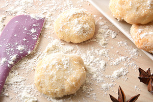Macro of freshly made anise cookies on wooden bench elevated, a Food & Drink Photo by Davizro's Market
