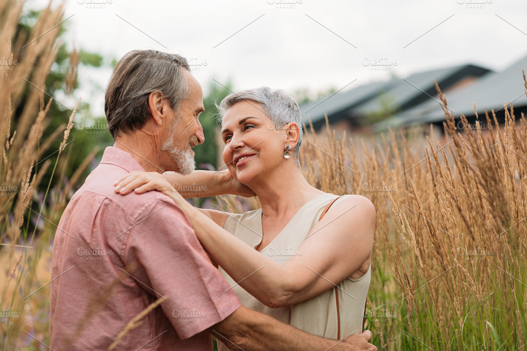 Two senior people standing together, a Person Photo by Artem Varnitsin