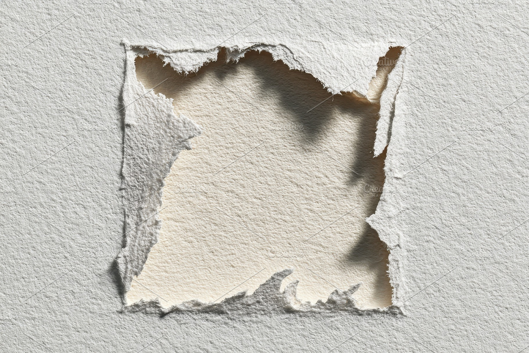 Torn Paper Reveals Beige Underlayer, a Photo by Pixeness Studio
