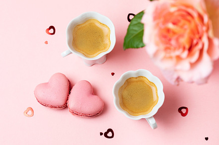 Romantic setup with coffee, macarons and roses