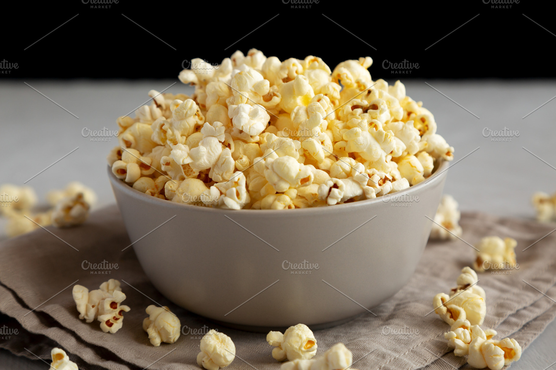 Homemade Salty Popcorn in a Bowl, side view., a Food & Drink Photo by LiudmylaChuhunova