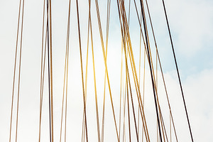 Rope cables against cloudy sky, a Photo by Dvoevnore photos