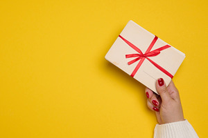 A woman's hand in a white sweater holds a stack of blank postcar, a Holiday Photo by ndanko