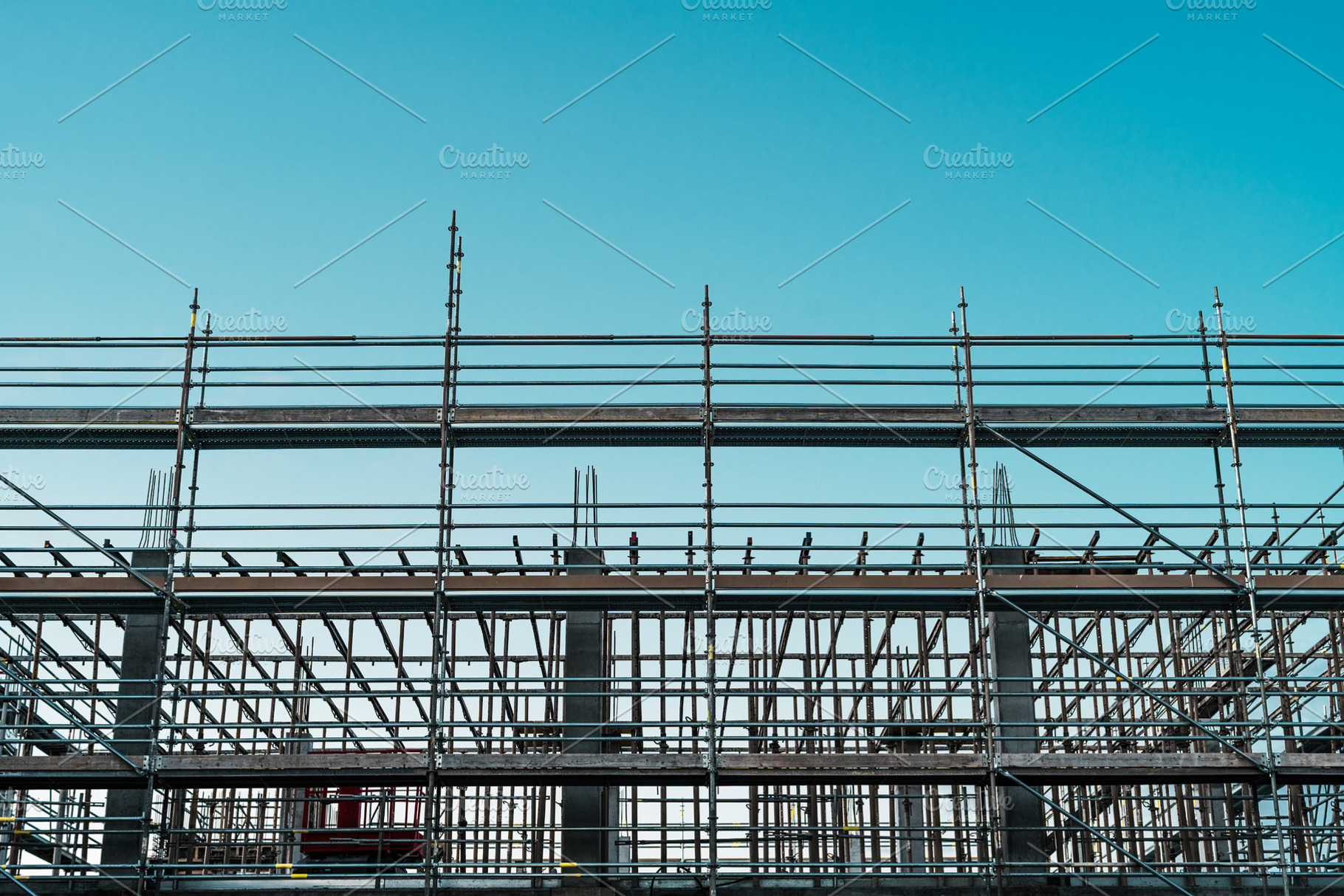 Construction scaffolding under blue sky, an Industrial Photo by SkyNext