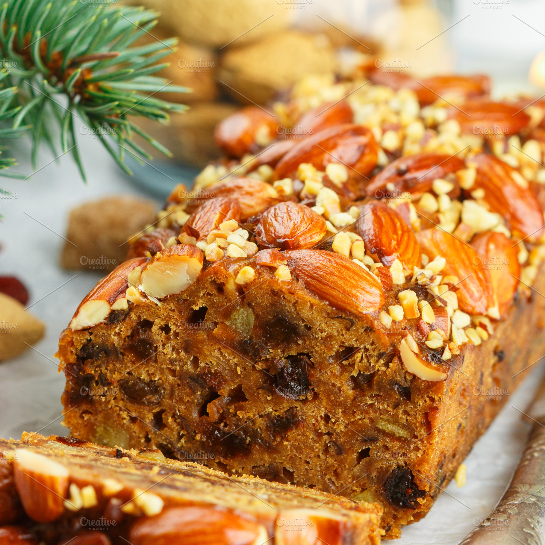 Traditional christmas fruitcake containing christmas, fir, and almonds, a Food & Drink Photo by La_Vanda