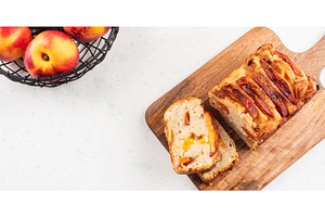 Peach cake loaf on wooden cutting, a Food & Drink Photo by Lifemorning