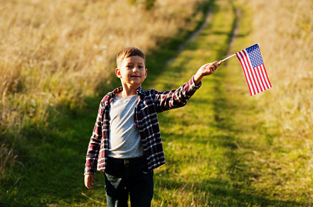 Little boy with USA flag outdoor. America celebrating., a Person Photo by AS photostudio