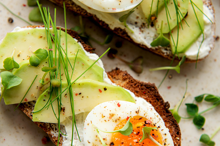 Bread toast, boiled eggs, avocado slice, microgreens on a plate, a Food & Drink Photo by Olena Rudo