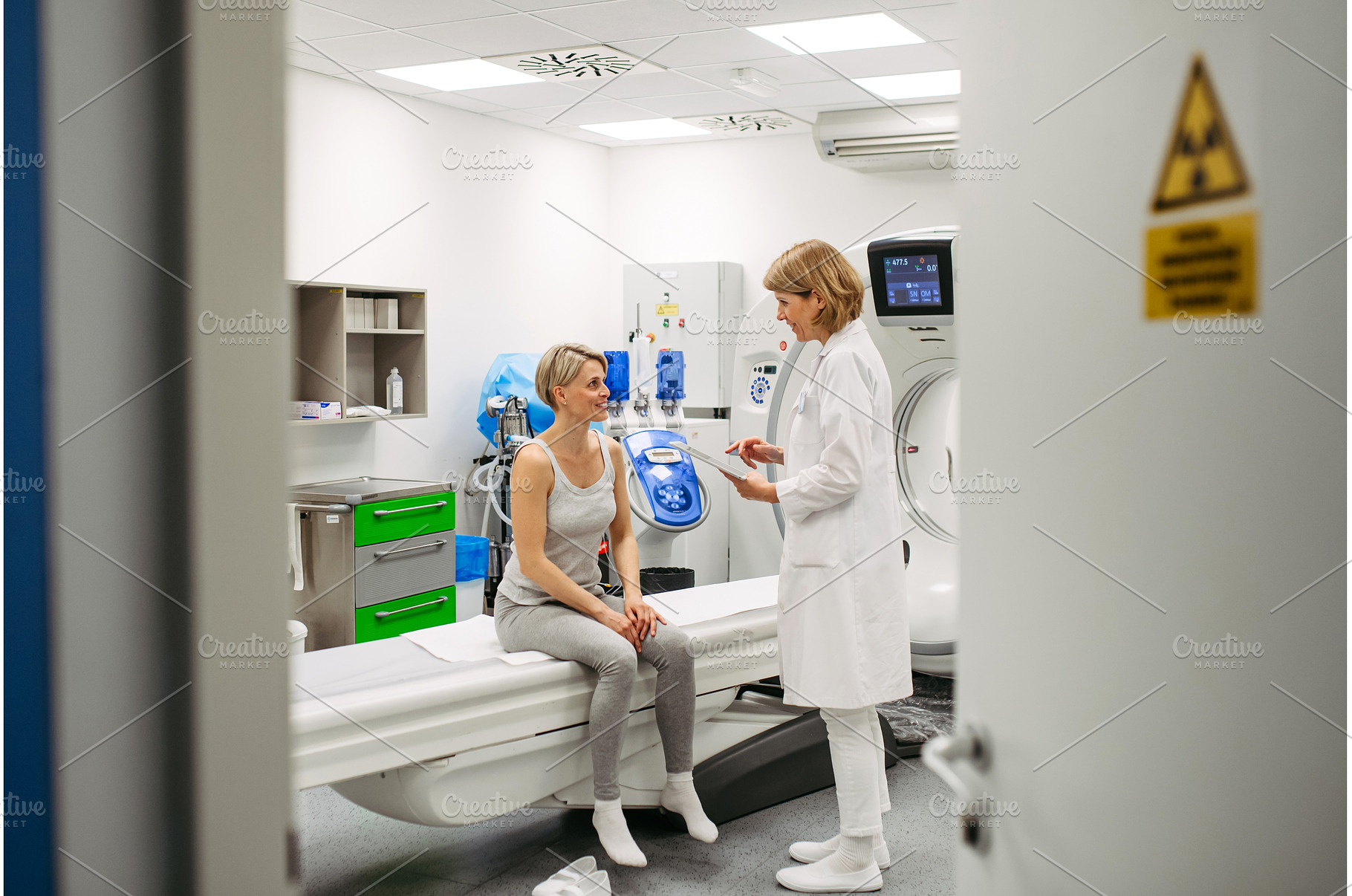 Doctor sharing positive CT scan, a Health & Medical Photo by HalfPoint