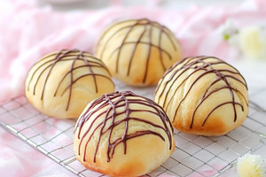 Easter chocolate drizzled sweet buns on cooling rack with soft p, a Photo by Dvoevnore photos