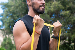Man doing bicep curl with resistance band, a Sports & Recreation Photo by etorres69