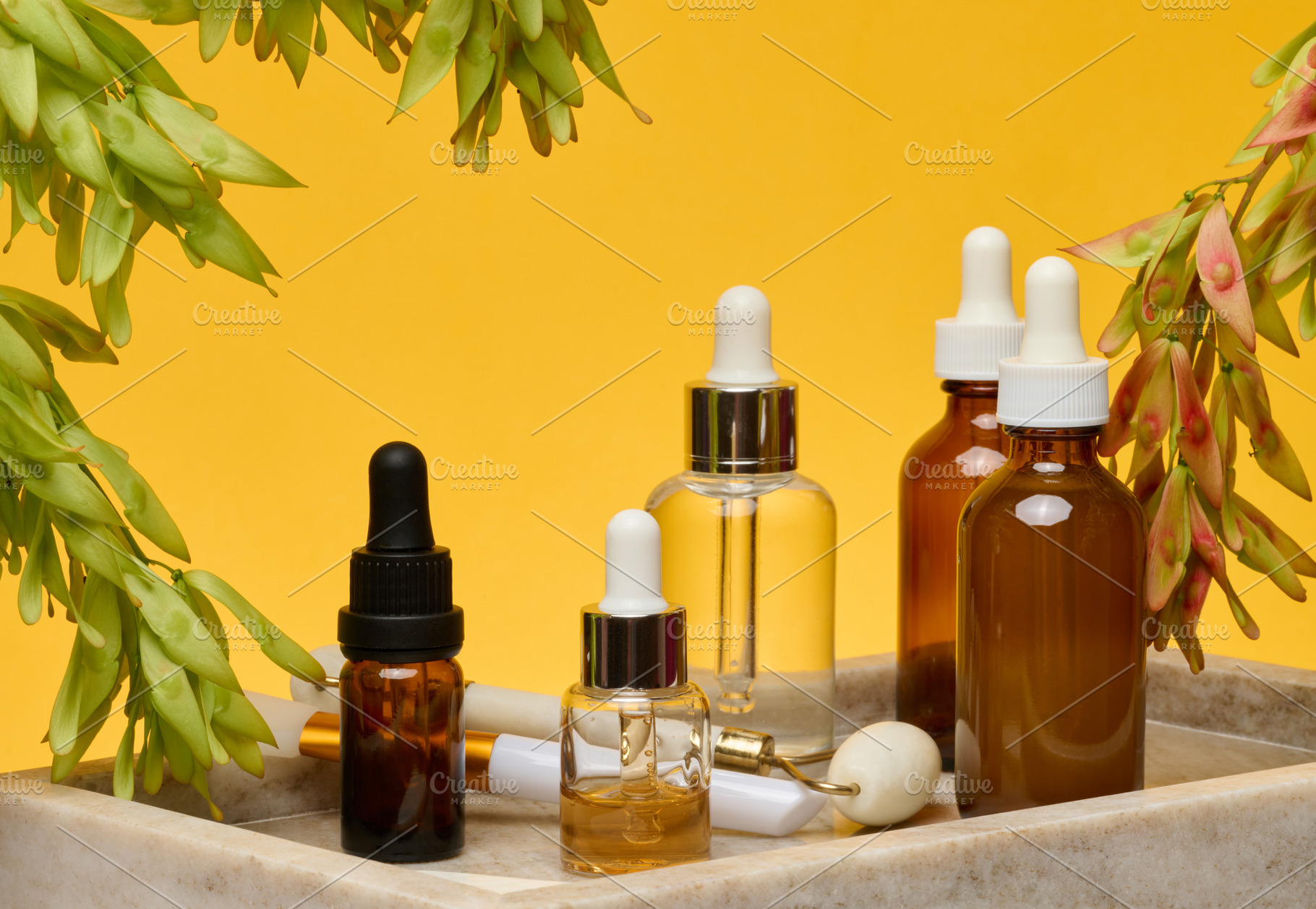 Stone rollers and gua sha with glass bottles with pipettes stot, a Food & Drink Photo by ndanko