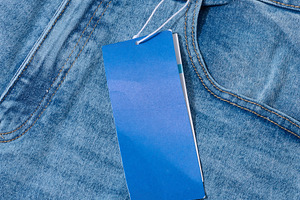 Close-up of light blue denim jeans with a blank blue price tag a, a Beauty & Fashion Photo by ndanko