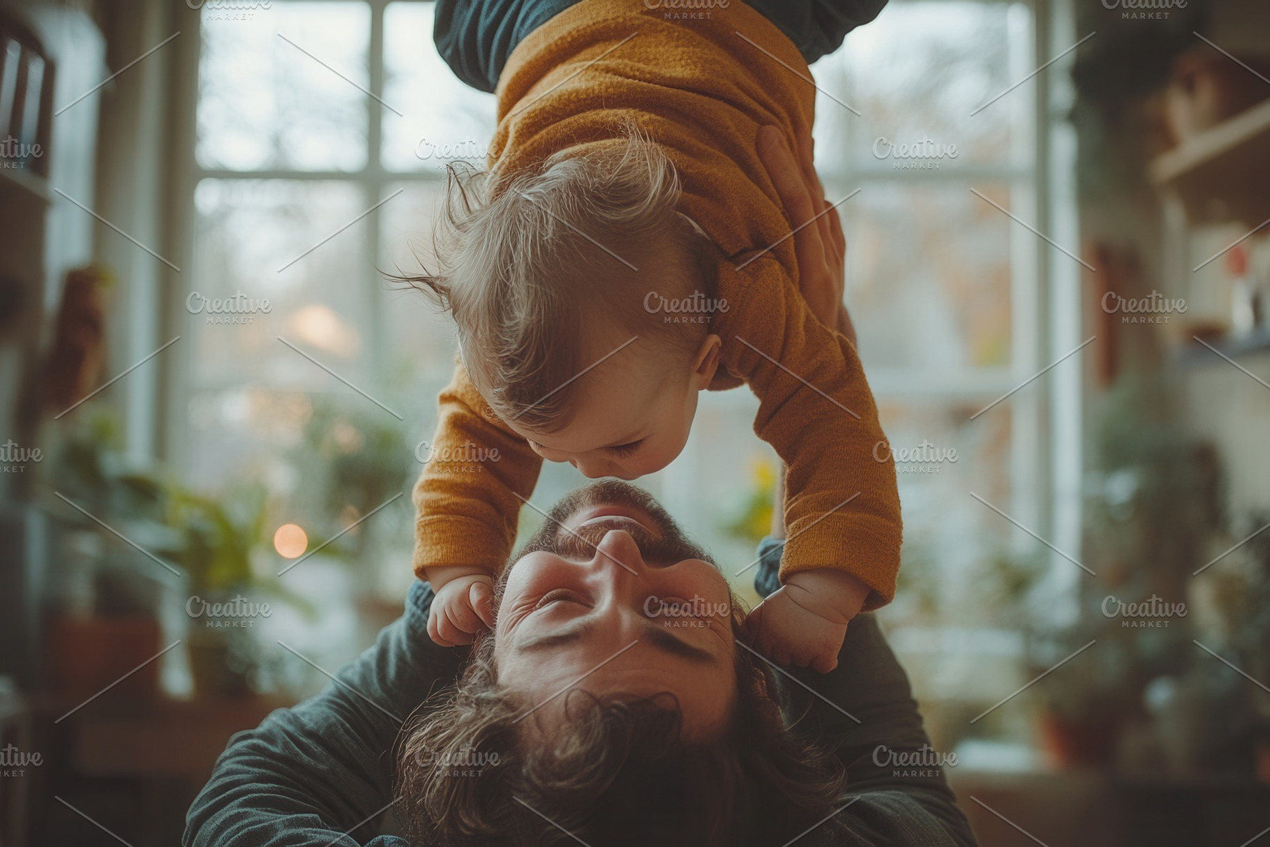 Father plays joyfully with his baby,, a Photo by Tanuart