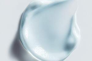 Light blue cosmetic cream swatch with smooth texture on a white, a Photo by Studio ANNA
