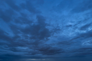 Dramatic dark blue clouds sky with thunder storm and rain at nig