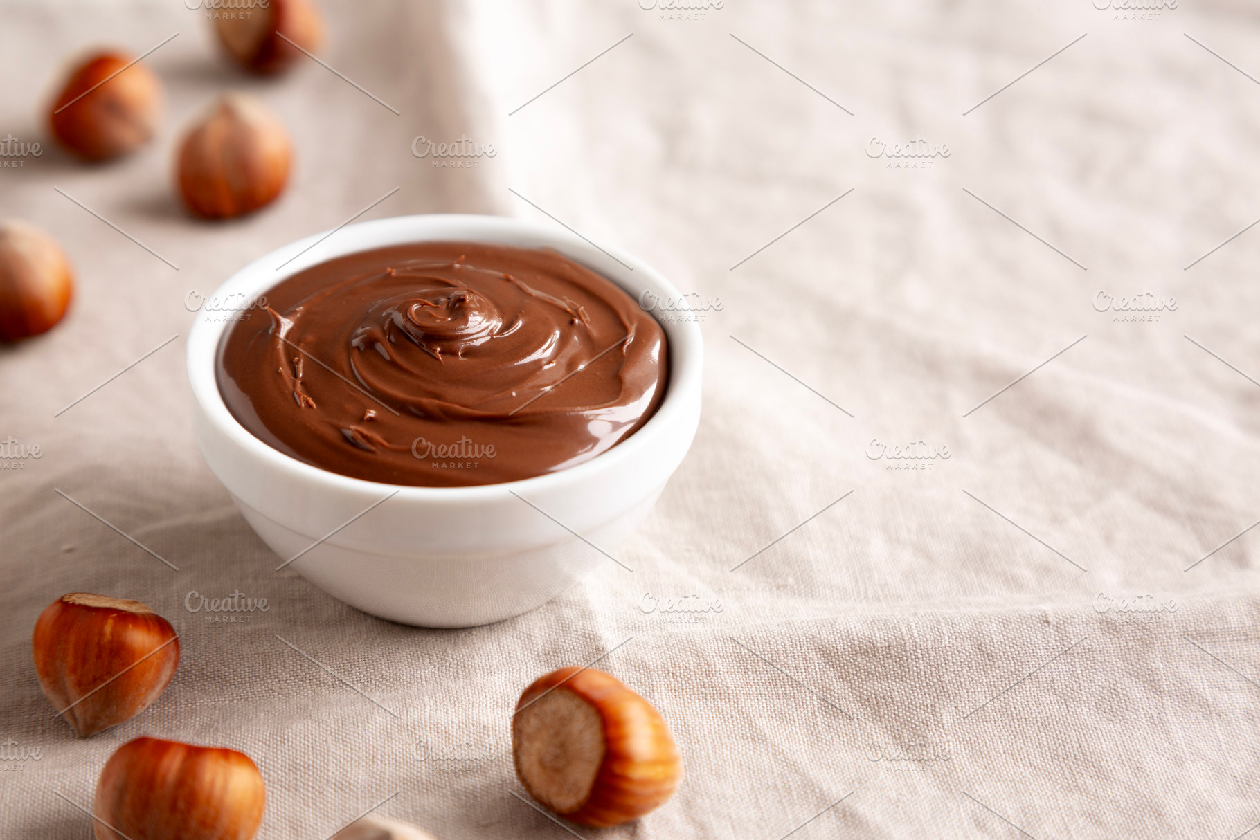 Homemade Chocolate Hazelnut Spread in a Bowl, side view. Copy sp, a Food & Drink Photo by LiudmylaChuhunova