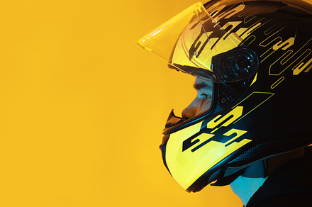 man in a helmet on a yellow background , copy space