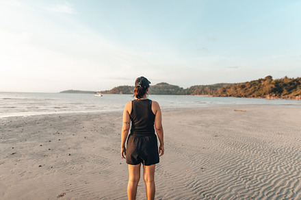 Woman walking along the beach in the evening, a Nature Photo by Art Rachen