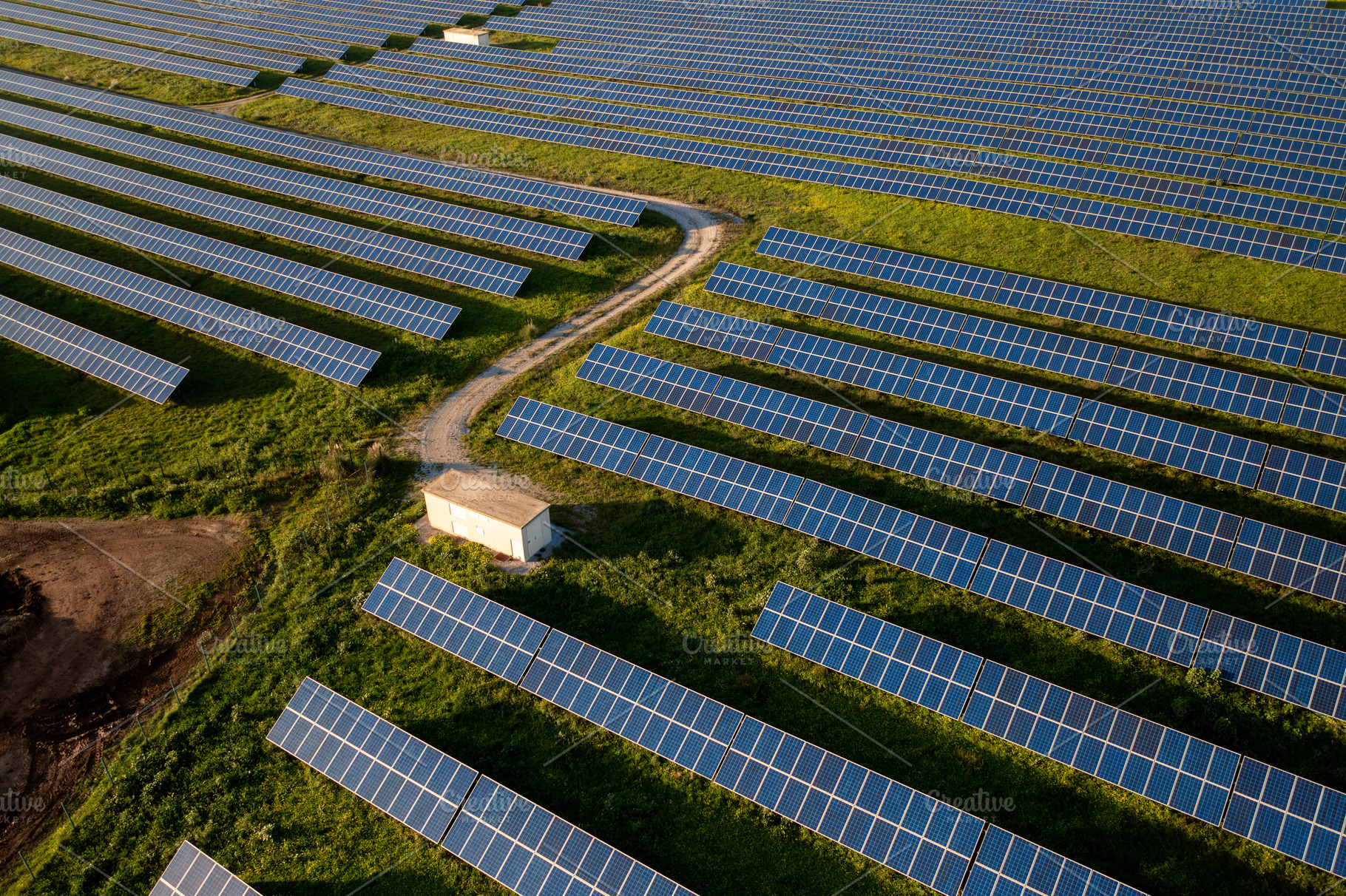 Aerial shot of landscape equipped with solar panels during daytime, a Photo by andreonegin market