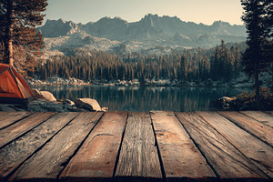 Campsite is set up near a calm lake, a Photo by Pavel_design