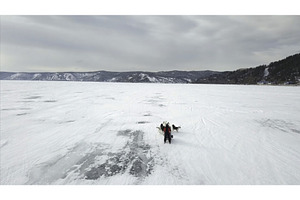 Dog Sledding On A Frozen Lake In