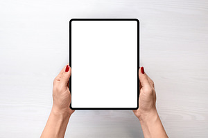 Girl holding iPad Pro - top view, a Technology Photo by RSplaneta