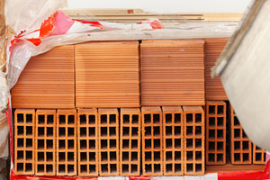 Pallet of hollow bricks ready for building construction, an Industrial Photo by Antonio Gravante Market
