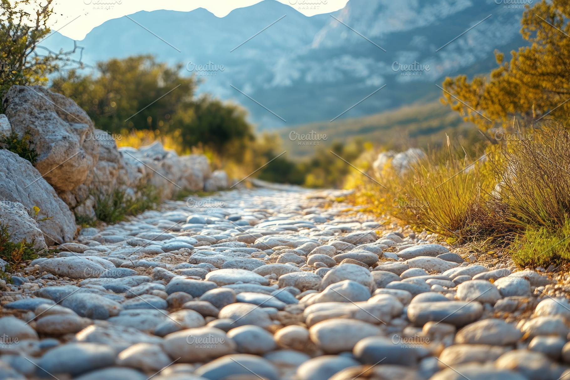 A scenic view of a winding stone path surrounded by greenery and mountains., a Background Photo by ImageMir