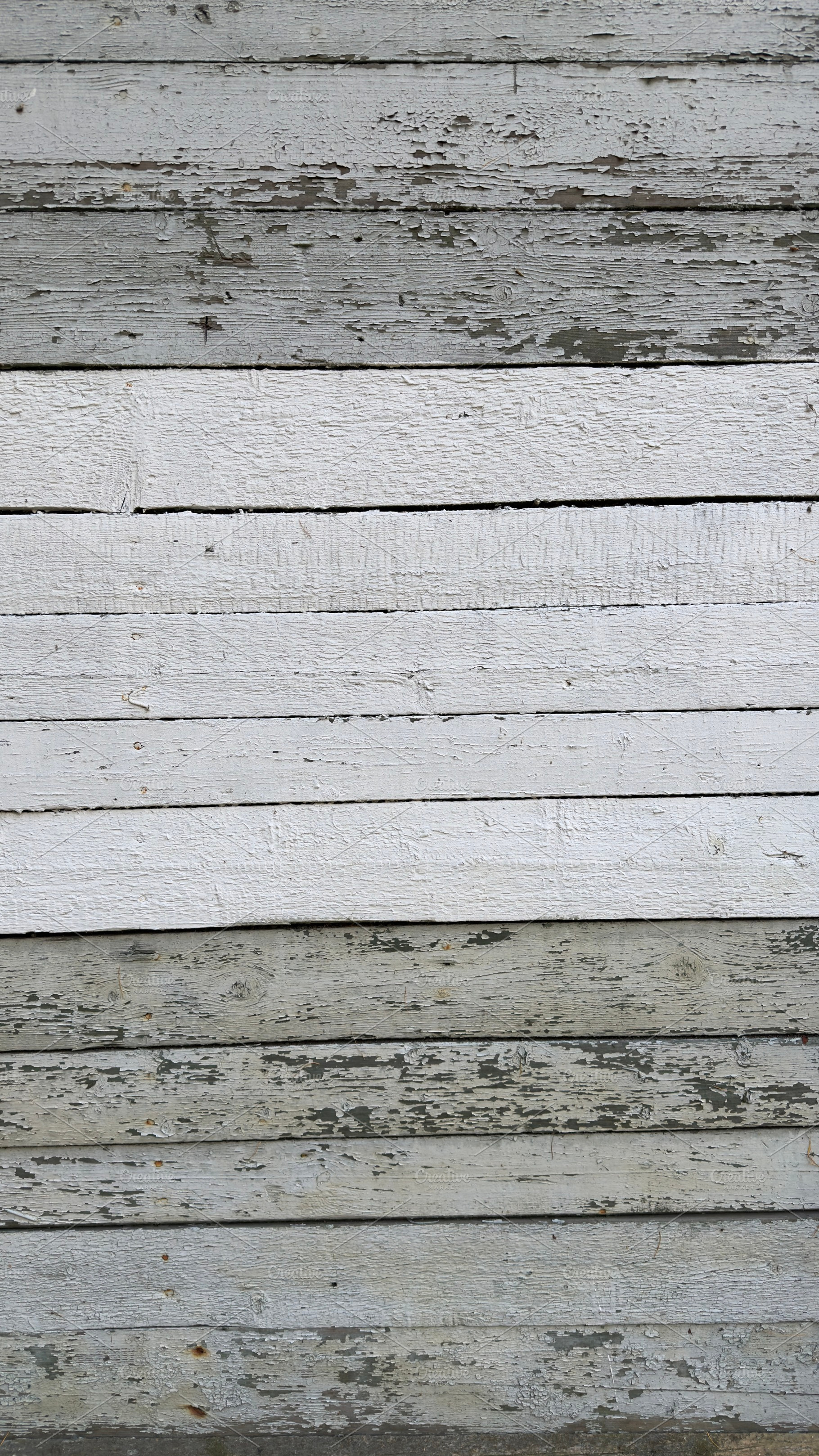 A textured wooden wall with alternating white and gray planks, showing signs of, a Nature Photo by Textures & Backgrounds