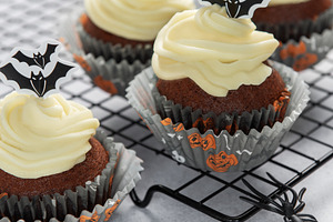 Halloween cupcakes with frosting and spooky bat decorations, a Food & Drink Photo by Olena Rudo
