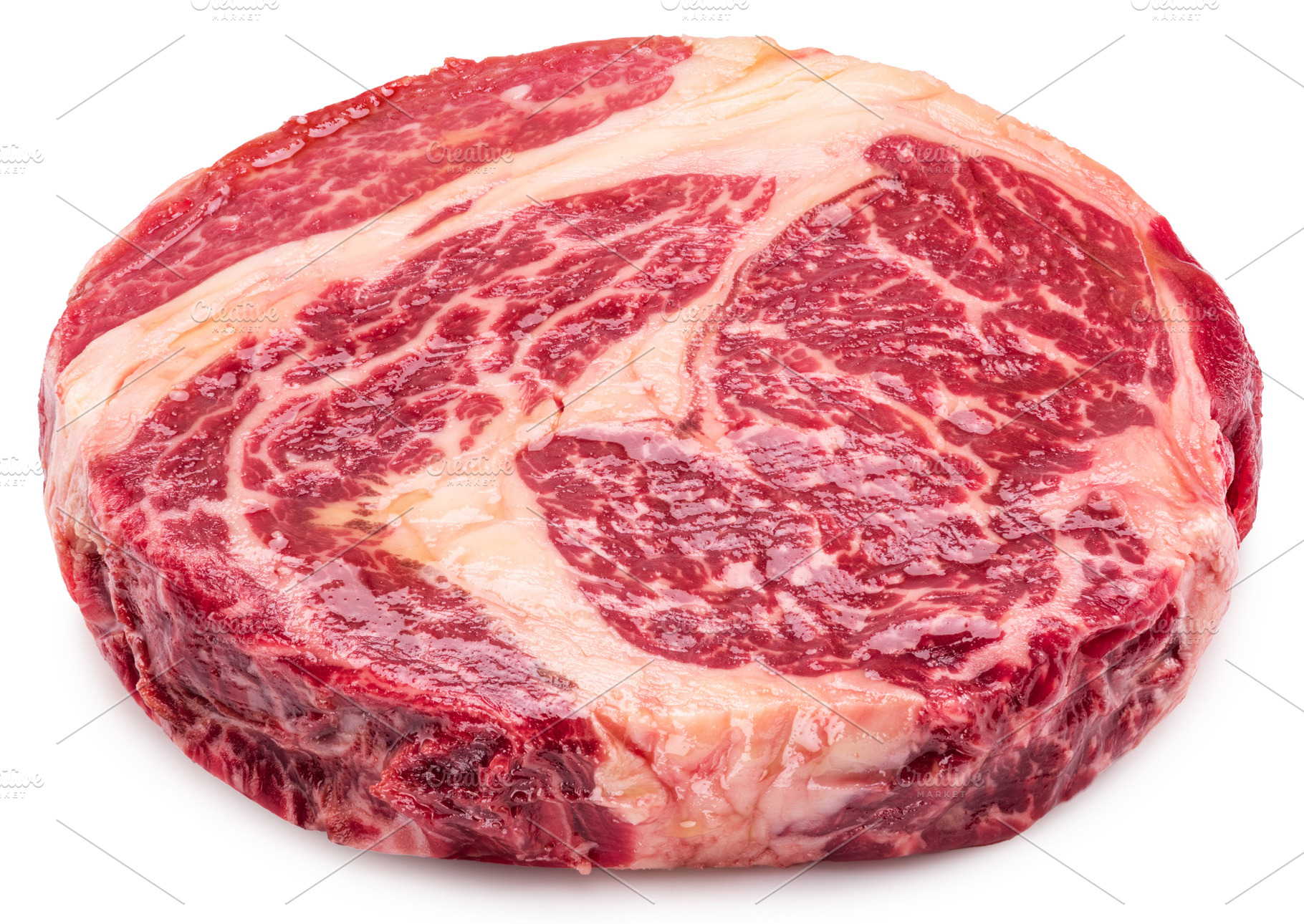 Raw ribeye steak on white background, a Food & Drink Photo by Volff