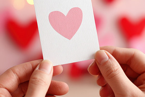 Holding a heart card for love celebration, a Holiday Photo by AlyaAnd