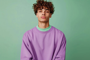 Young attractive man in sweatshirt on green background, a Person Photo by AlyaAnd