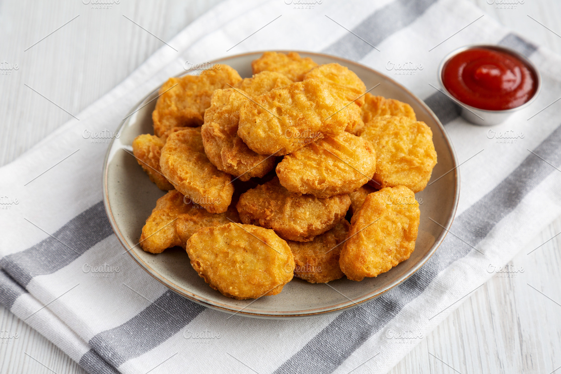 Homemade Chicken Nuggets with Ketchup, side view., a Food & Drink Photo by LiudmylaChuhunova
