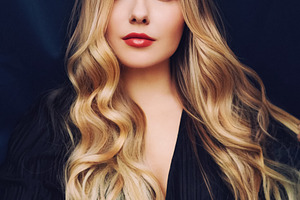 Young woman with long wavy blonde hair, blue eyes, and red lipst, a Person Photo by Anneleven