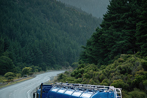 Blue tanker truck on mountain road m, a Photo by Pixeness Studio