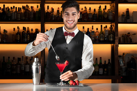 Young barman serving a cocktail at night club., a Person Photo by david.herraez.calzad