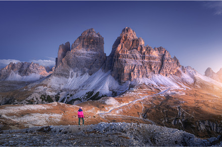 Woman on the hill and mountain peaks