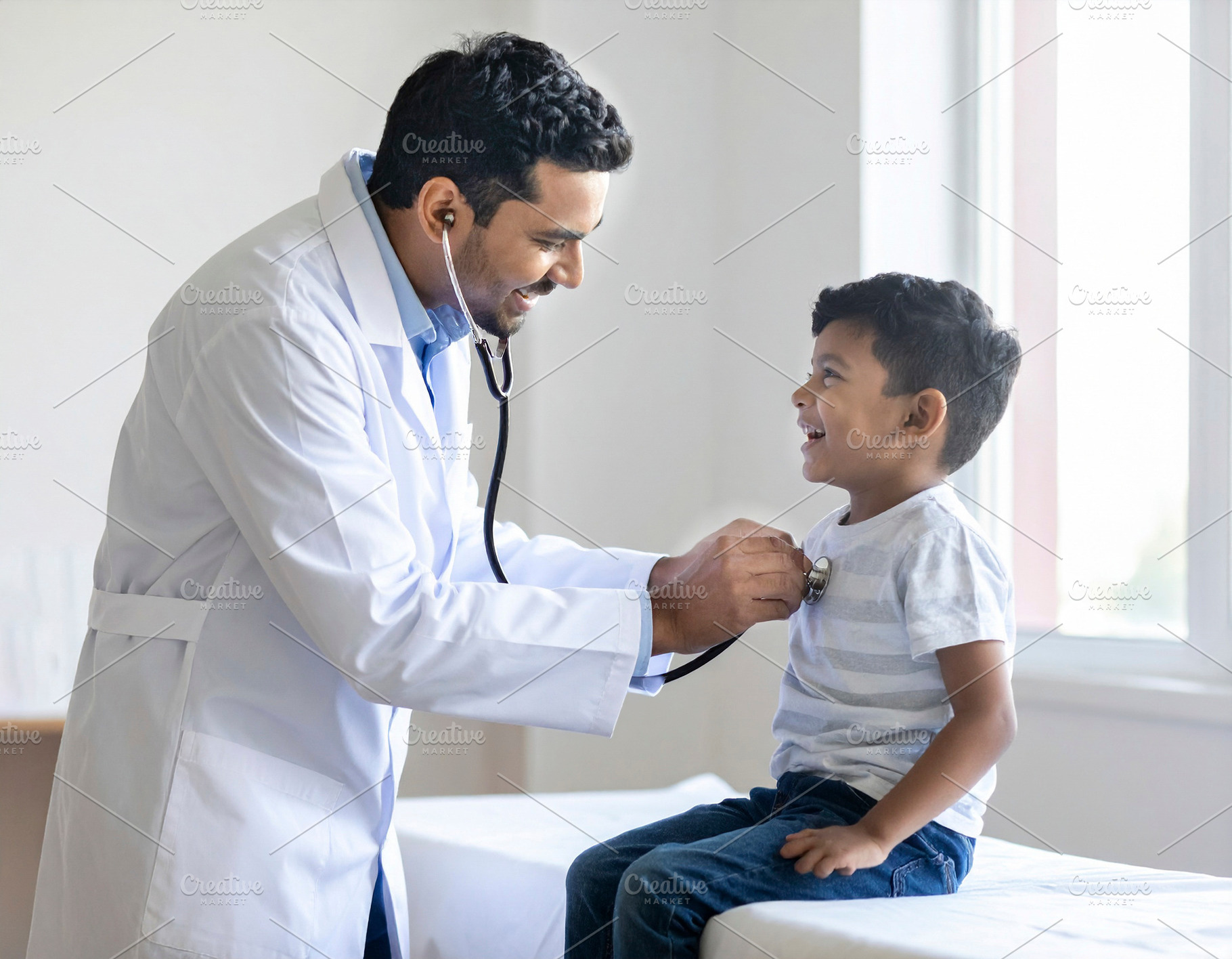 Pediatrician examining a cheerful child with a stethoscope in a, a Health & Medical Photo by DanFLCreativo