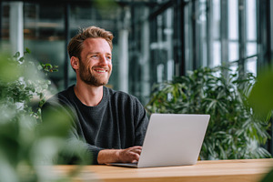 Man works on laptop in bright space, a Photo by Beautiful things