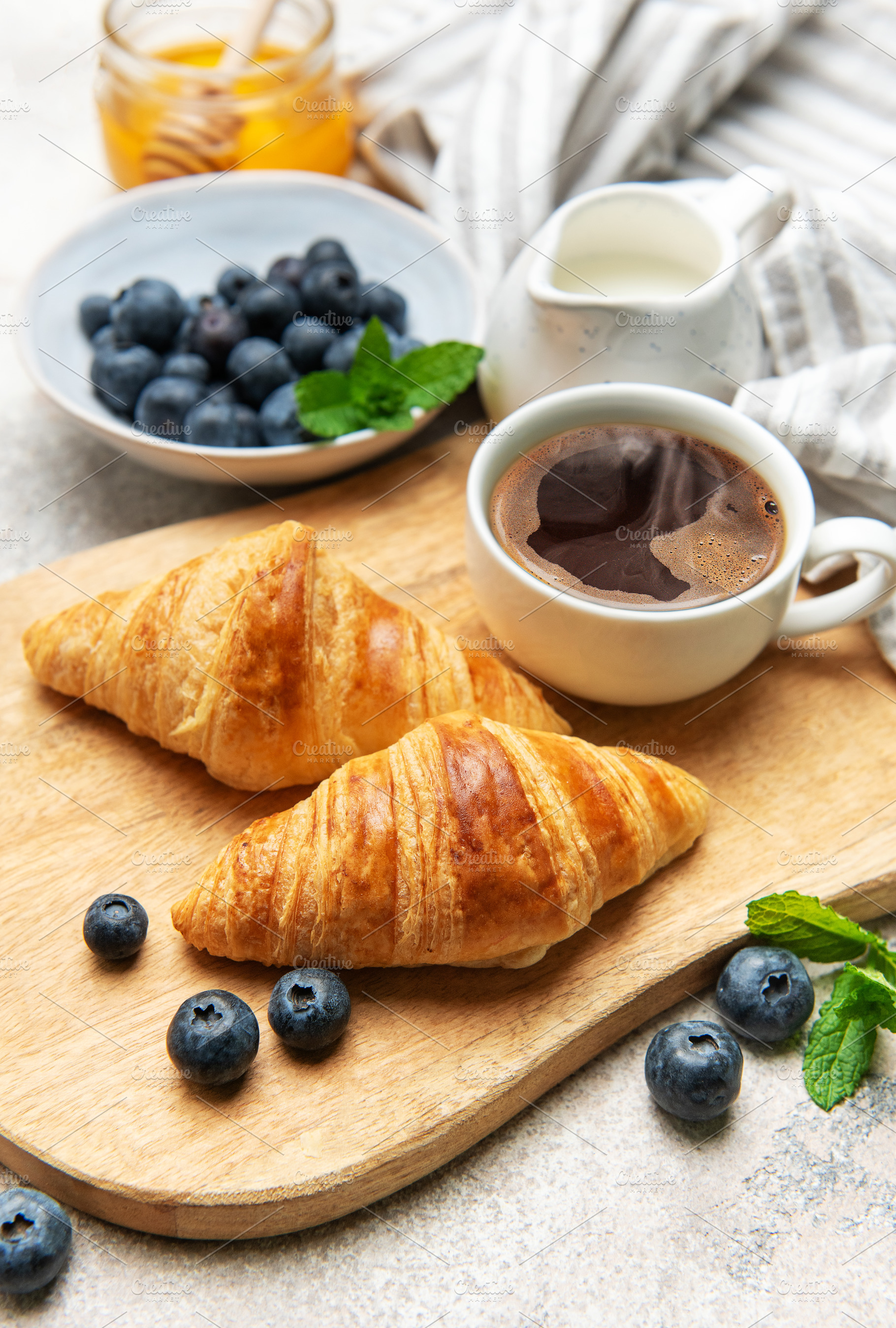 Delicious french croissants with coffee, honey and fresh blueber, a Food & Drink Photo by Olena Rudo