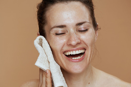 happy woman with towel washing face, a Person Photo by Alliance Images
