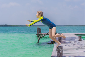 Boy jumping off a pier into a, a Holiday Photo by Elizaveta Galitskaya