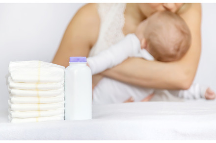 mother changes baby's diaper on a, a Person Photo by yanadjana