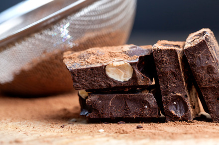 divided into parts chocolate bar with whole nuts, a Background Photo by MyPhotos
