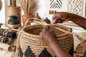Afrobohemian home decor with woven basket and fiber art as backg, a Photo by Dvoevnore photos