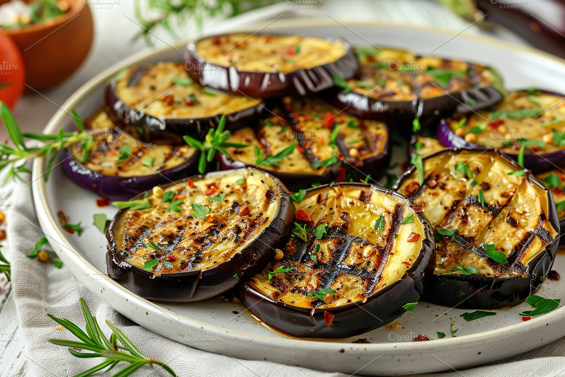 Grilled eggplants in plate on wooden table, a Food & Drink Photo by AlyaAnd