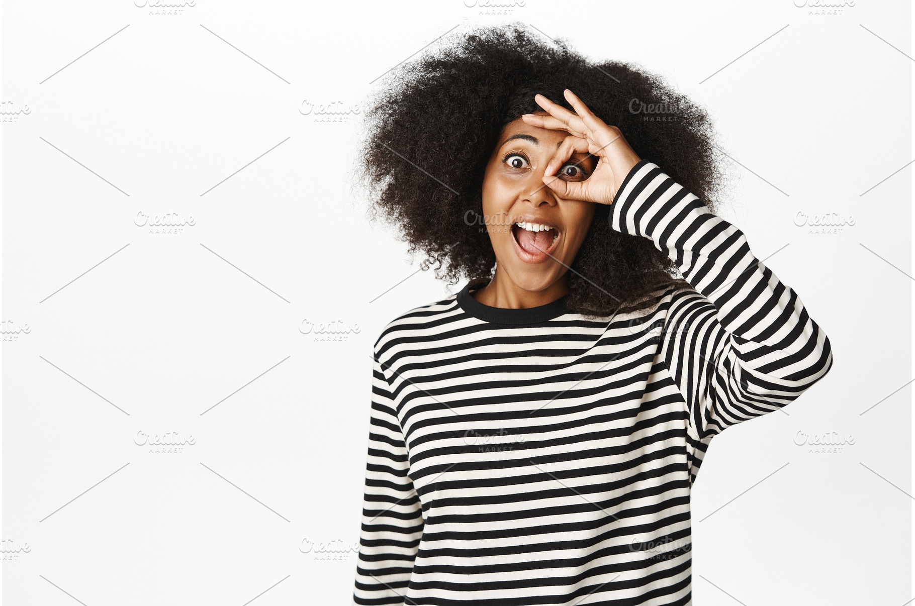 Excited young african woman shows, a Person Photo by Cookie Studio