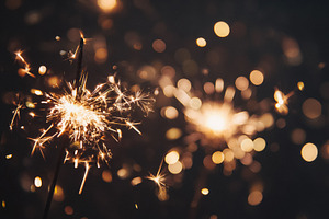 Sparklers shining bright at night, creating festive sparks and g, a Photo by Studio ANNA